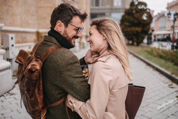 istock Young couple walking down the street 1358823230