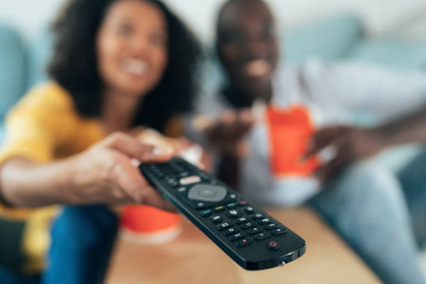 istock Happy couple watching tv 1358823390