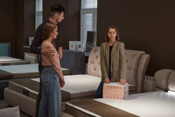 istock Young couple selecting new mattress in store 1358824537