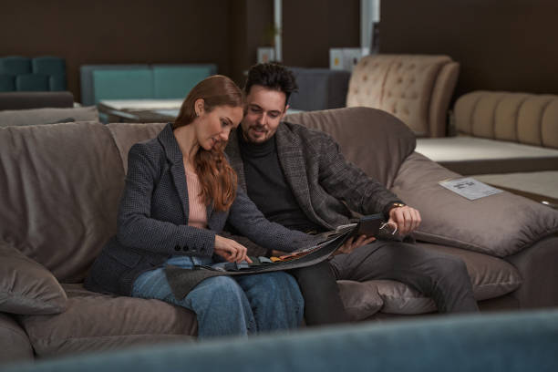 istock Focused young couple looking at fabric swatches 1358824587