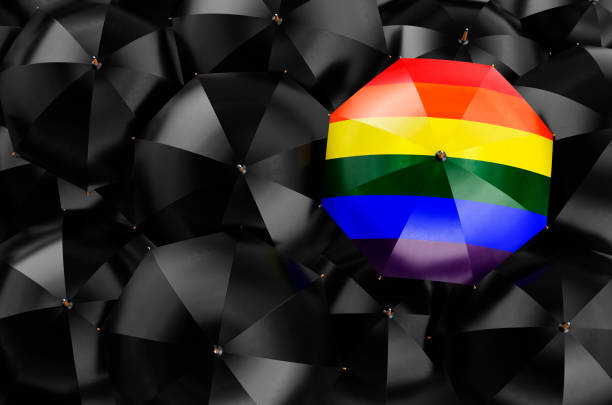 istock Umbrella with LGBT rainbow flag among black umbrellas, 3D rendering 1358827525