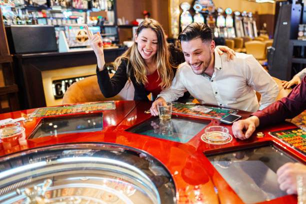 カジノでルーレットを演奏する友人の興奮したグループ - roulette roulette wheel gambling roulette table ストックフォトと画像