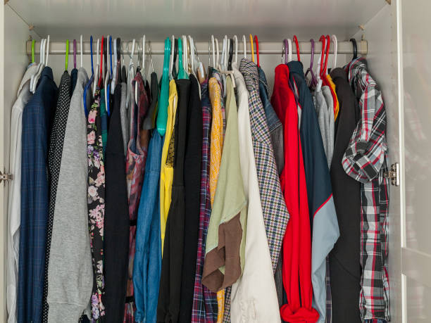 istock wardrobe with hanging clothes, filled wardrobe, storing clothes at home, saving 1358829391