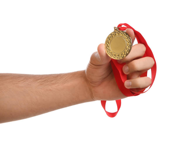 istock Man holding golden medal on white background, closeup. Space for design 1358830572
