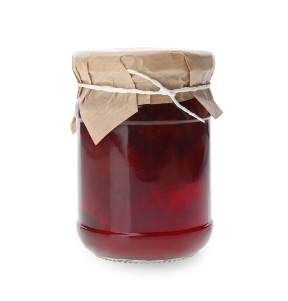 istock Jar of pickled strawberries isolated on white 1358830689