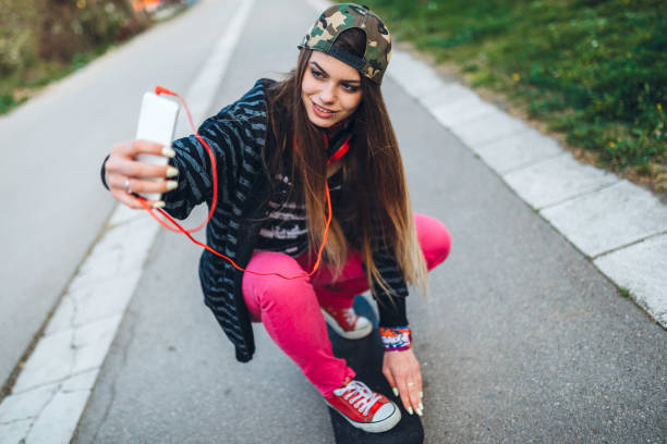 istock Female Skater Taking Selfies 1358830824