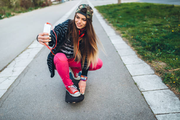 istock Female Skater Taking Selfies 1358830848