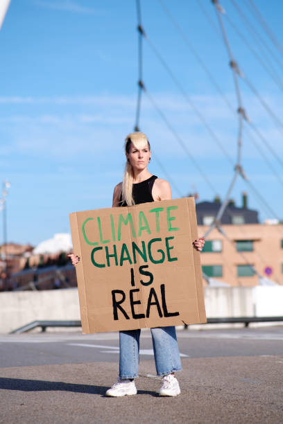 istock A young female protester holding a placard with a climate change theme 1358832402