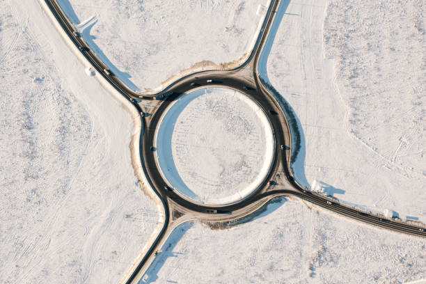 Traffic circle road, sunny winter, aerial top view