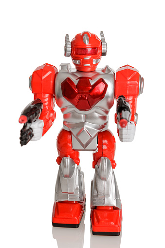 Toy robot clockwork on batteries in red, space fiction, toy for boys, isolated on a white background
