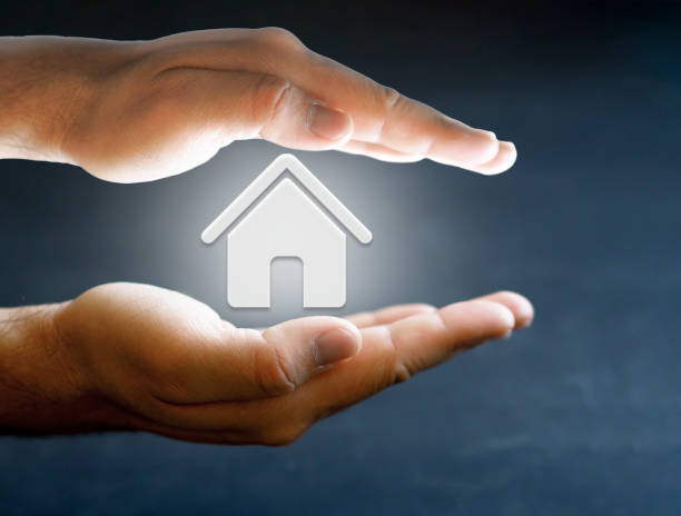 istock concept hand protection photo with house and black background 1358840053