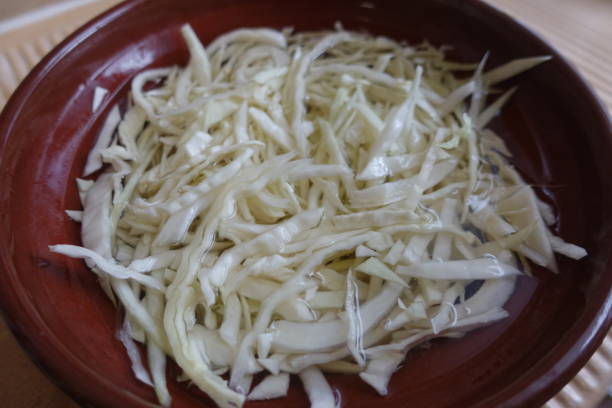 istock Shredded white cabbage in preparation for a mixed salad 1358840253
