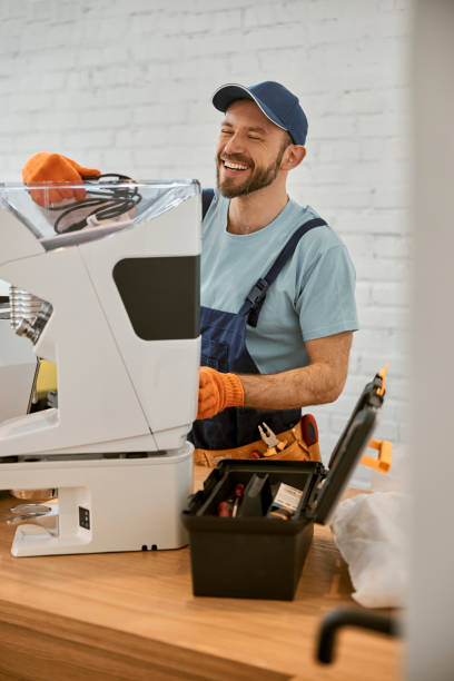 istock Joyful repairman fixing coffee machine in cafe 1358842532