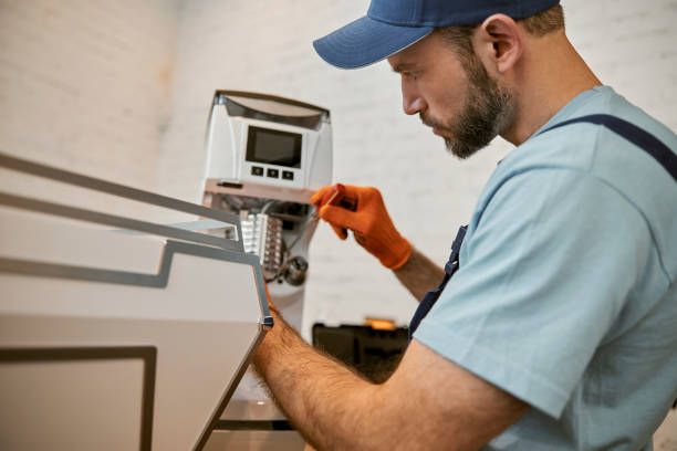 istock Bearded repairman fixing coffee machine in cafe 1358842538
