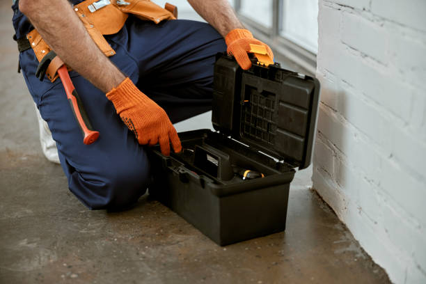 istock Male electrician in work gloves using tool box 1358842550