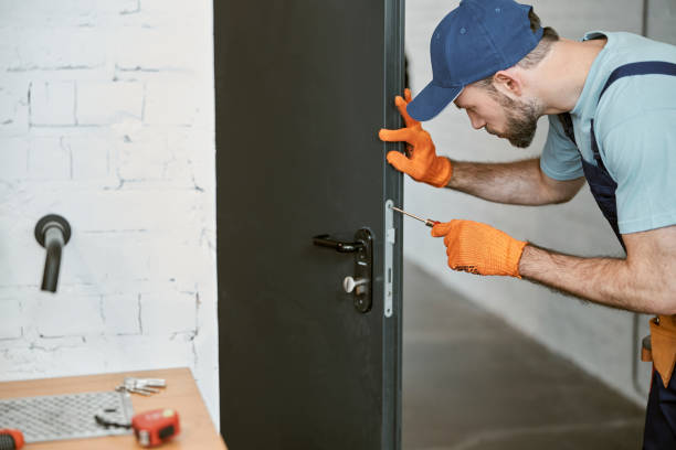istock Bearded young man fixing door with screwdriver 1358842590