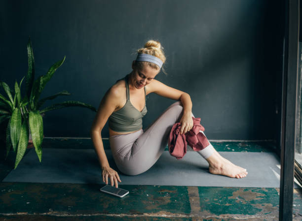 istock Smiling Woman Using Mobile Phone at Yoga Studio 1358843449