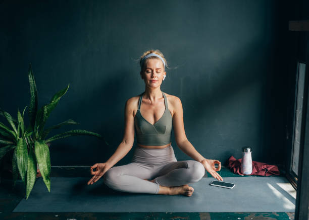 istock Beautiful Woman Practicing Yoga at Home 1358843468