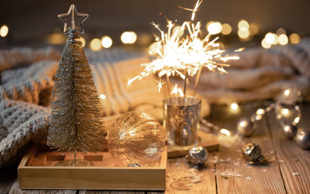 istock Cozy Christmas background with glowing sparklers and decor details. 1358844300