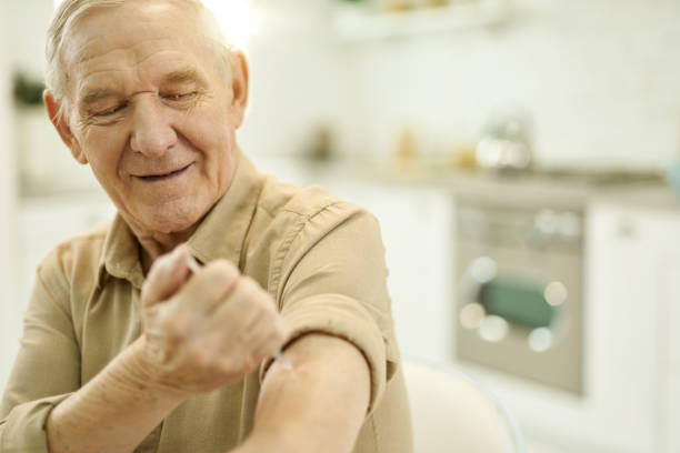istock Independent senior man giving himself an arm injection 1358844710