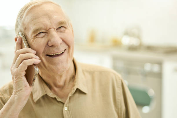 istock Joyous aged gentleman having a pleasant phonecall 1358844716
