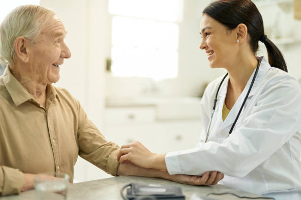 istock Friendly doctor getting along well with her elderly patient 1358844746