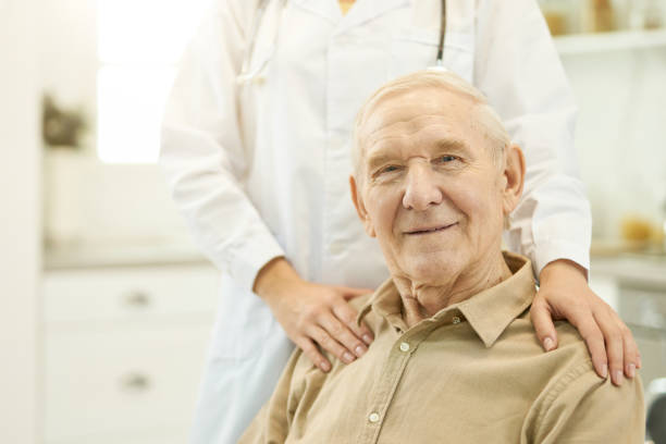 istock Contented elderly man posing with his medical doctor 1358844751