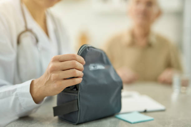 istock Medicare staff opening a black case with medical device 1358844766