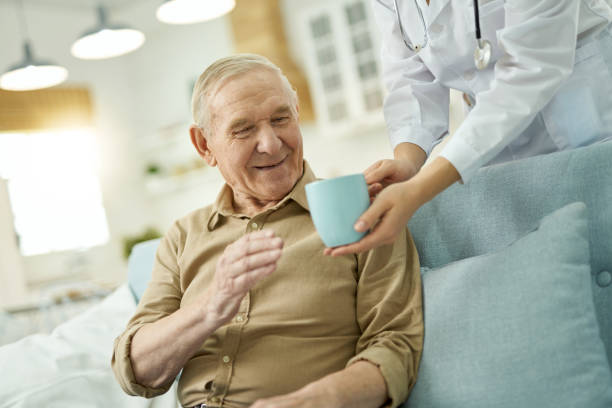 istock Happy aged man going to drink a hot drink at home 1358844774