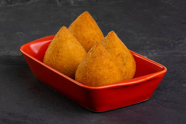 istock traditional fried coxinha in a red container on a slate stone 1358845732