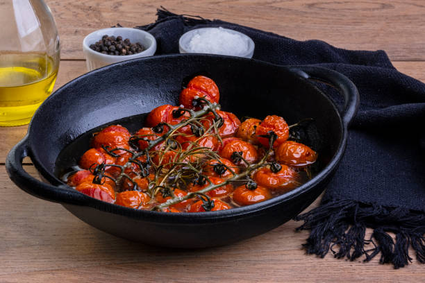 istock iron casserole with confit tomatoes on wood table 1358845736