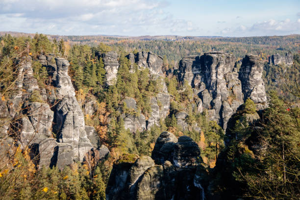 istock Basteiaussicht or Bastei Rock Formations in Elbe River Valley, Sandstone Mountains Path, autumn forest landscape at sunny day, rocky valley 1358847029