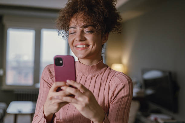 istock A young mixed race woman is using a mobile phone 1358848104