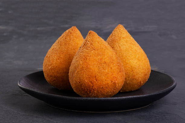 traditional fried coxinha on a black plate on a slate background - brazilian snack traditional fried coxinha on a black plate on a slate background - brazilian snack. savory food photos stock pictures, royalty-free photos & images