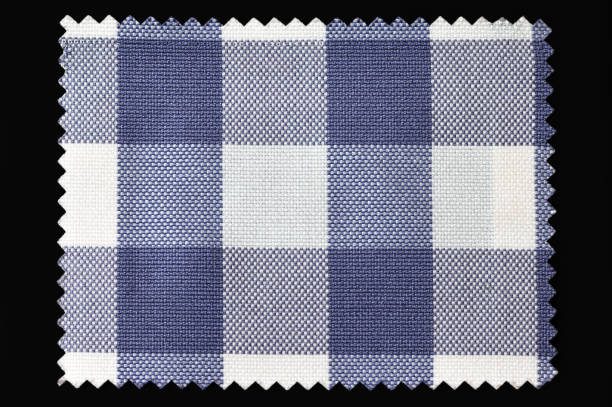 istock Blue and white checkered fabric sample isolated on black background 1358848402