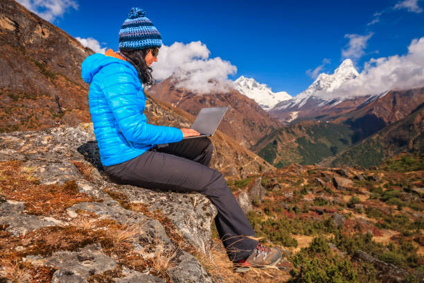 istock Young woman using laptop in Himalayas, Nepal 1358851587