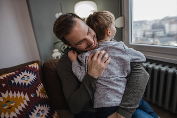 istock Portrait of a young boy hugging with his father 1358852483