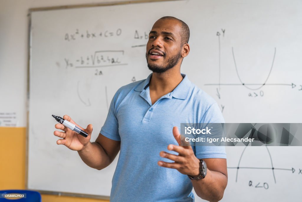 Math teacher in the classroom Teacher Stock Photo