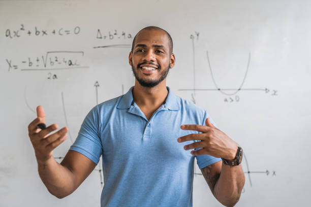 Math teacher in the classroom Enthusiastic math teacher in the classroom scientist photos stock pictures, royalty-free photos & images