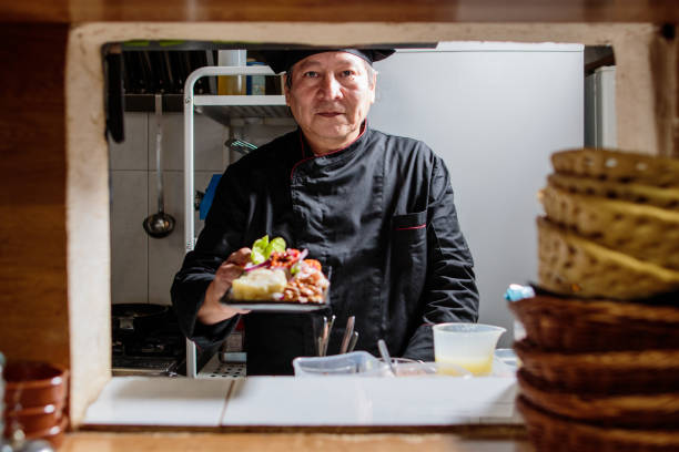 istock Peruvian Latinx senior chef cooking ceviche. Recipe Preparation ingredients in bistro kitchen 1358853635