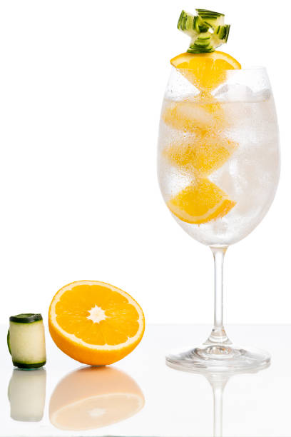 istock gin and tonic cocktail with orange and cucumber on white background. 1358854526