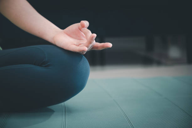 istock Asian woman practicing yoga at home to relax during lockdown 1358854596
