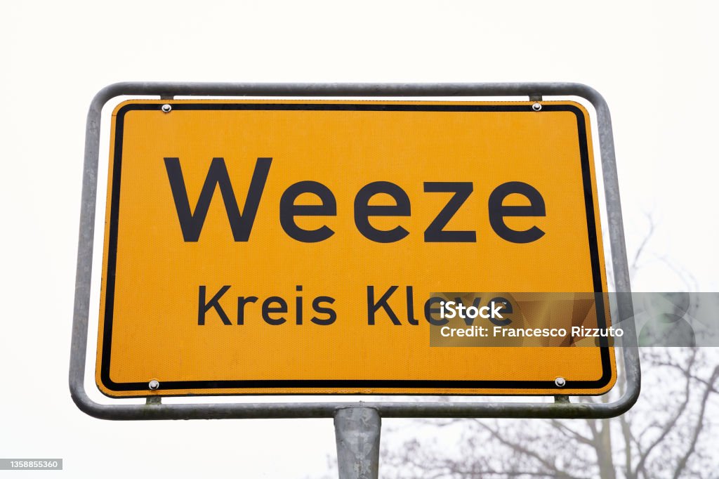 The street sign Weeze in the Kleve district in Germany. Close to the Dutch border. Airport Stock Photo