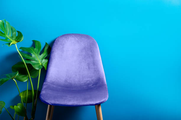 Modern Blue Velour Chair on wooden legs stock photo