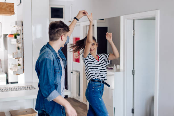 istock Happy young couple dancing at home and having fun 1358857222