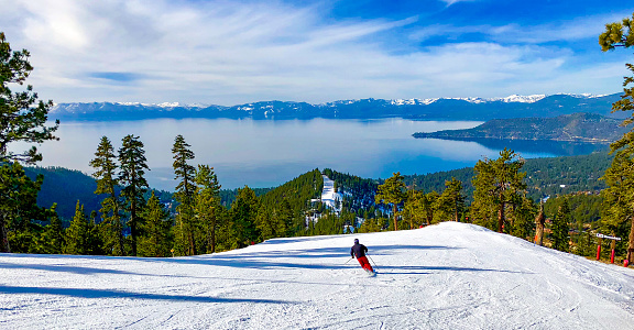 Downhill skiing with Lake Tahoe in the background