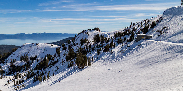 Looking down Little Cottonwood Canyon in winter over a bowl at the top of Snowbird ski resort, Utah.