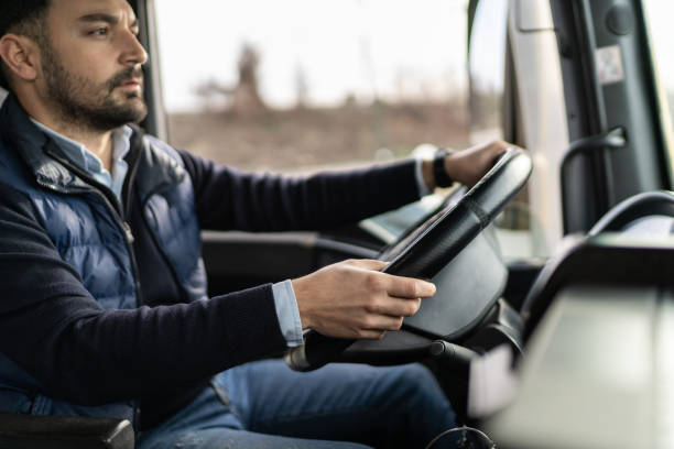 istock Truck driver sitting in cabin and preparing for drive 1358859703