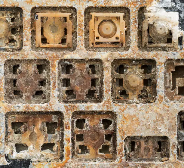 Close up detail of destroyed and corroded vandalised laptop computer keyboard with cover removed and dumped
