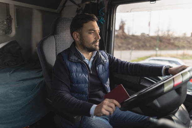 istock Truck driver preparing passport for border control 1358862922